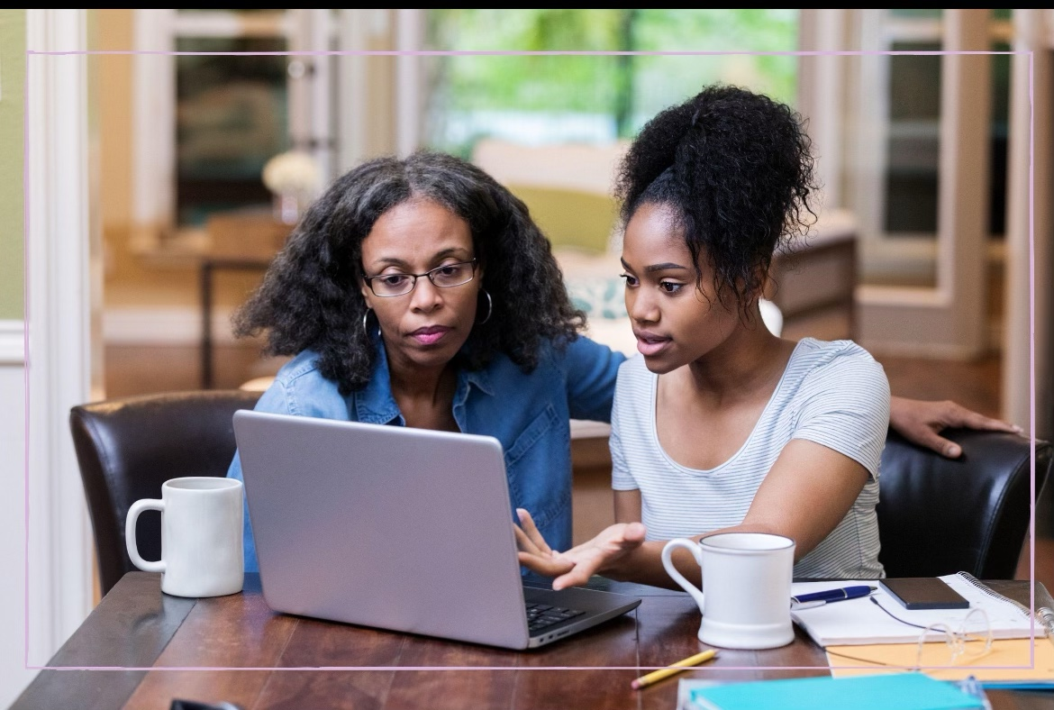 A student and a parent reviewing college plans together at home