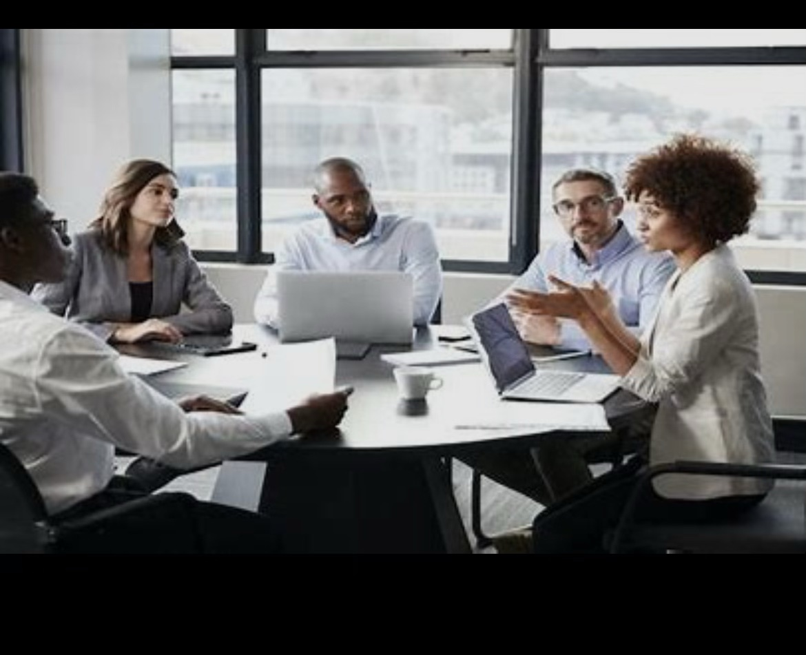 A diverse group of organization leaders meeting around a table